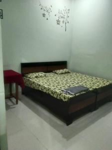 a bedroom with a bed and a red table at 2 Room set floor in Mathura