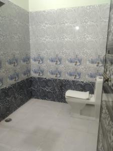 a bathroom with a toilet and a sink at 2 Room set floor in Mathura