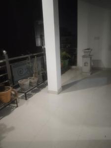 a white room with a pillar and some pots at 2 Room set floor in Mathura