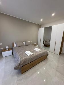 a bedroom with a bed with two towels on it at Nicola's Apartments in Santa Maria La Carità
