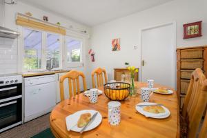a kitchen with a wooden table with food on it at Cosy country cottage, nearby beaches attractions A55 in Llysfaen +12 photos