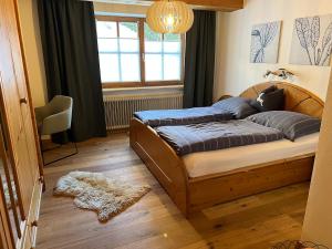 a bedroom with a bed and a window at Ferienwohung Walcher in Grossarl