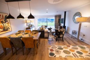 a living room with a dining table and a couch at Heather Lodge in Comrie