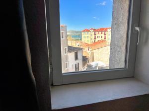 a window with a view of a city at L'Antique - Cocon, Centre Historique, Wifi , 4 lits, 6 personnes in Istres
