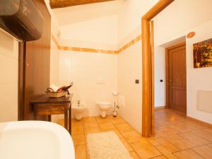 a bathroom with a toilet and a sink in a room at Agriturismo La Cantina in Farigliano