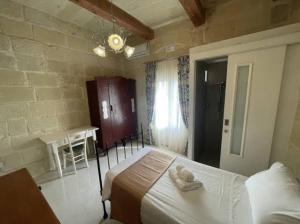 a bedroom with a bed and a table in it at 71 San Antonio in Victoria