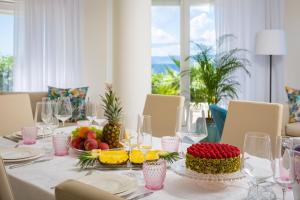 a table with a white table cloth with fruit on it at La Villa - BEACHFRONT - INFINITY HEATED POOL - NEW in Sutivan