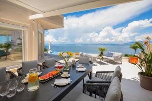 a dining room with a view of the ocean at La Villa - BEACHFRONT - INFINITY HEATED POOL - NEW in Sutivan