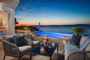 a living room with a view of the ocean at La Villa - BEACHFRONT - INFINITY HEATED POOL - NEW in Sutivan