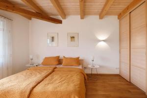 a bedroom with a large bed and two tables at Birkethof Fernblick in Grimoldsried +23 photos