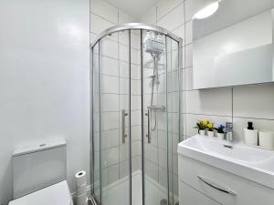 a bathroom with a shower and a sink at Comfy Studio 30min to Central London in London