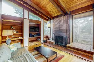 a living room with a couch and a fireplace at Elk Mid-Century - Guest House in Elk