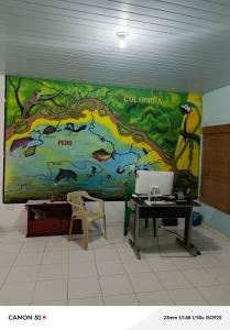 a large mural on the wall of a room with a desk at Alojamiento LETICIA in Leticia