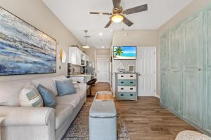 a living room with a couch and a ceiling fan at Inn at Seacrest 309- Somewhere in the Sun in Inlet Beach