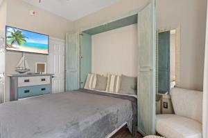 a bedroom with a large bed and a chair at Inn at Seacrest 309- Somewhere in the Sun in Inlet Beach +22 photos