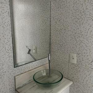a sink in a bathroom with a mirror at Motel Wish in Campinas