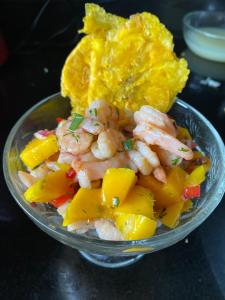 a bowl of food with shrimp and pineapple on a table at Pachaea Hotel campestre in La Vega