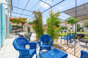 a group of blue chairs and tables on a patio at Moun Oustau in Avignon