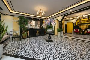 a lobby with a white and black tile floor at Grand Hanoi Hotel in Hà Ðông
