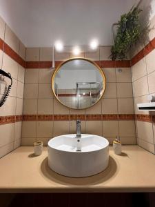 a bathroom with a sink and a mirror at Levanda Cozy Apartments in Lefkada +68 photos