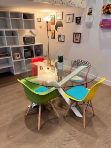 a glass table and chairs in a living room at RaRoom Luxury R-Aparthotel in Torre del Greco +14 photos