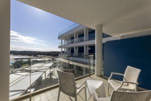 a balcony with chairs and a view of a building at Hotel Belvedere in Torre dell'Orso
