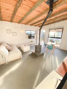 a living room with a bed and a fireplace at Mandalas de Mar in Punta Del Diablo