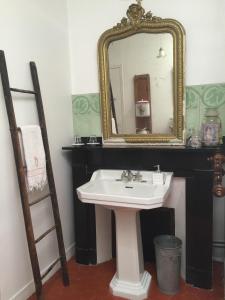 a bathroom with a sink and a mirror at Le logis blanc bed&breakfast in Coursan