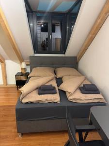 a bed with two pillows on it in a room at Modernes und helles Apartment VS in Villingen-Schwenningen