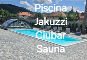 a swimming pool in a villa with the name of the resort at Gerab Resort in Praid