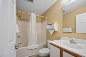 a bathroom with a sink and a toilet and a shower at Affordable Suites Wilson in Wilson +9 photos