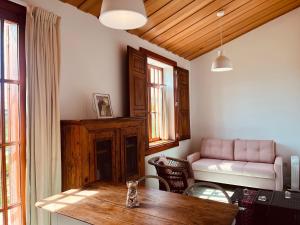 a living room with a table and a couch at Green Dunes House in Arcozelo