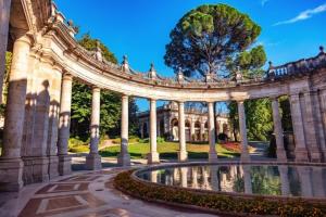 a large building with a fountain in a garden at Grand Hotel Bellavista Palace & Golf in Montecatini Terme