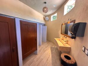 a bathroom with a sink and a mirror at Hotel Boutique Villa Ka'an in Calderitas