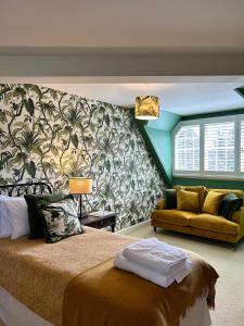 a bedroom with a large bed and a couch at Little Massingham Manor in Little Massingham