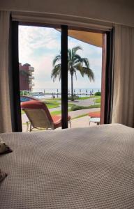 ein Schlafzimmer mit Bett und Blick auf den Strand in der Unterkunft Casa Amigos , entire 3 bedroom ground floor condo at Playa Grande Condominium Resort in El Coco