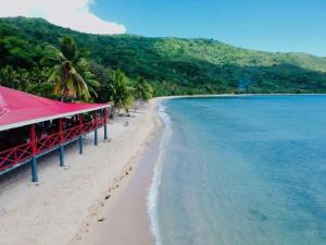 a view of a beach with a resort on it at Korovou Nature Lodge in Naviti Island