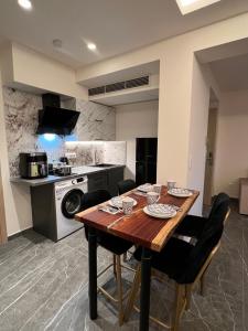 a kitchen with a wooden table and chairs in a room at Adas Terra - Boutique Apartments in Ano Poli Thessaloniki in Thessaloniki