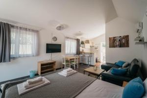 a room with a bed and a living room at Villa Vujeva in Pag