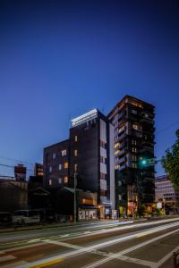a building on a city street at night at Sauna Hotel Gifu in Gifu