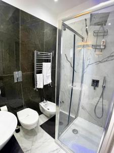 a bathroom with a shower and a toilet and a sink at Raroom Deluxe V Room in Torre del Greco