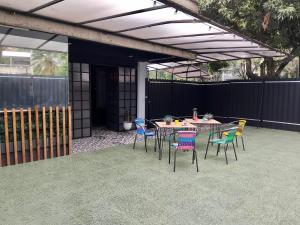 a patio with a table and chairs and a fence at Urban Oasis Med in Medellín