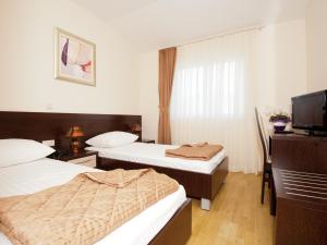 Postel nebo postele na pokoji v ubytování Hotel Orka