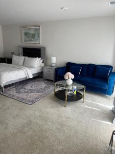 a living room with a bed and a blue couch at Home Away in Hanover