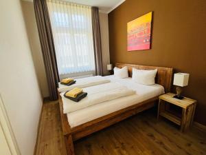 a bedroom with a bed with two towels on it at Apartment Central Leipzig-Zoo in Leipzig