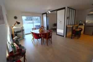 a kitchen and dining room with a table and chairs at L'Aigue Marine by Tranquil at Home in Pornichet