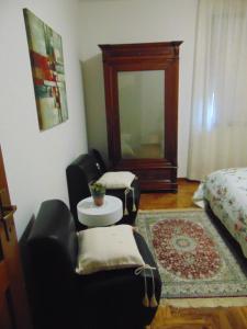 a room with two chairs and a table and a bed at Podere Luma Camera Gelsomino - Lavanda in Gambassi Terme