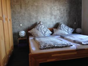 a bed with two pillows on it in a room at Ferienwohnung Kaspers in Schalkenmehren