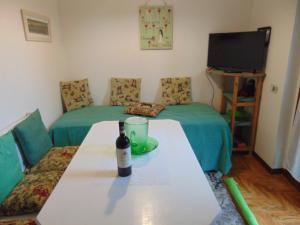 a room with a table with a bottle of wine on it at Podere Luma Camera Gelsomino - Lavanda in Gambassi Terme
