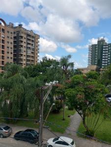 a parking lot with cars parked in a park at Vila Caiçara 80 metros da praia in Praia Grande